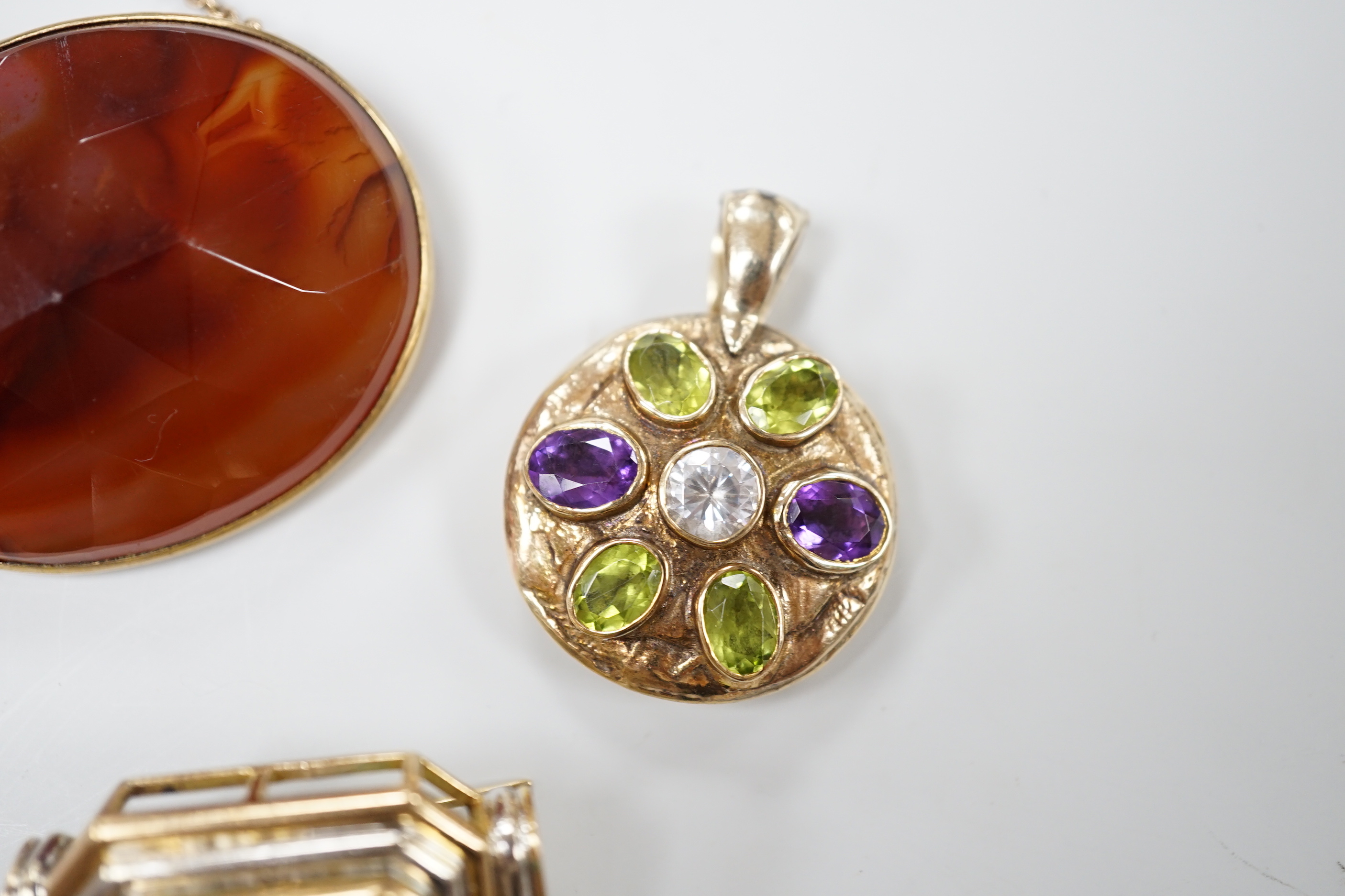 A modern 9ct gold, peridot, amethyst and simulated diamond cluster set circular pendant, diameter 27mm, together with a 9k and citrine set brooch and a yellow metal and facetted agate set brooch.